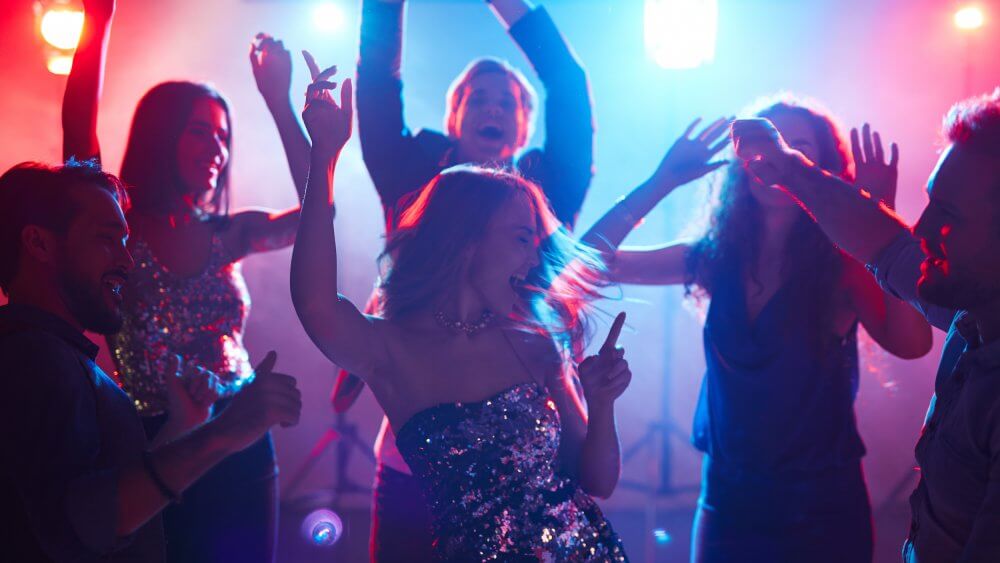 Ecstatic friends enjoying party with dancing