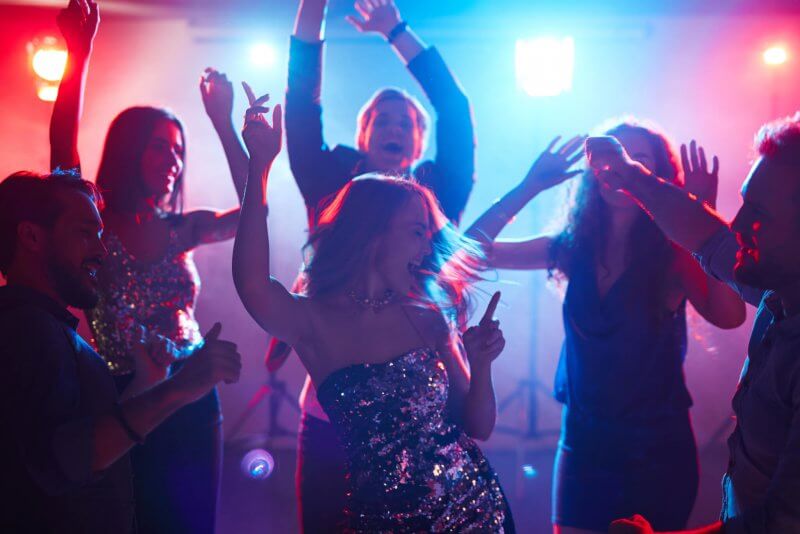 Ecstatic friends enjoying party with dancing