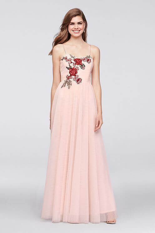 Girl in pink embroidered prom dress.