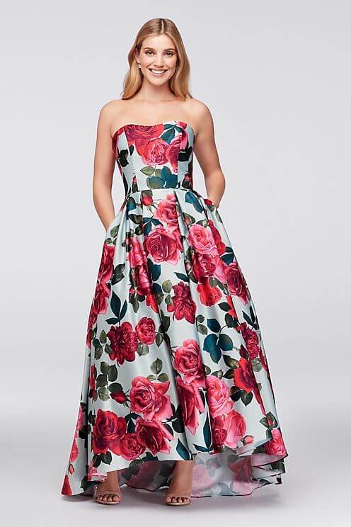 Girl in light blue and red floral strapless gown with pockets.